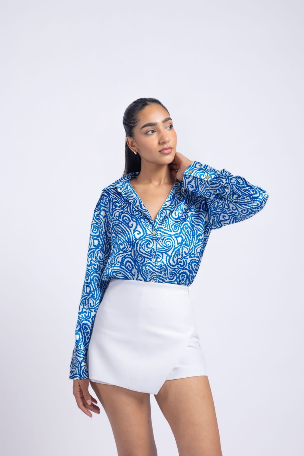 Blue satin shirt with a printed pattern.