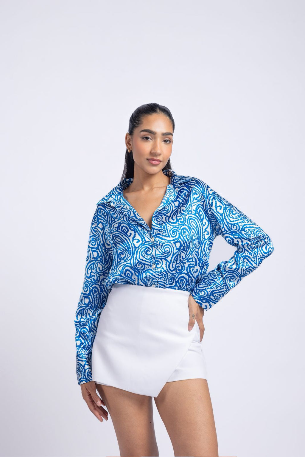 Blue satin shirt with a printed pattern.