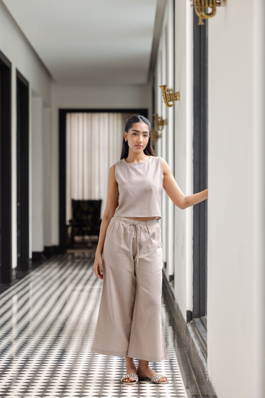 Sleeveless crop top paired with elastic-waist trousers