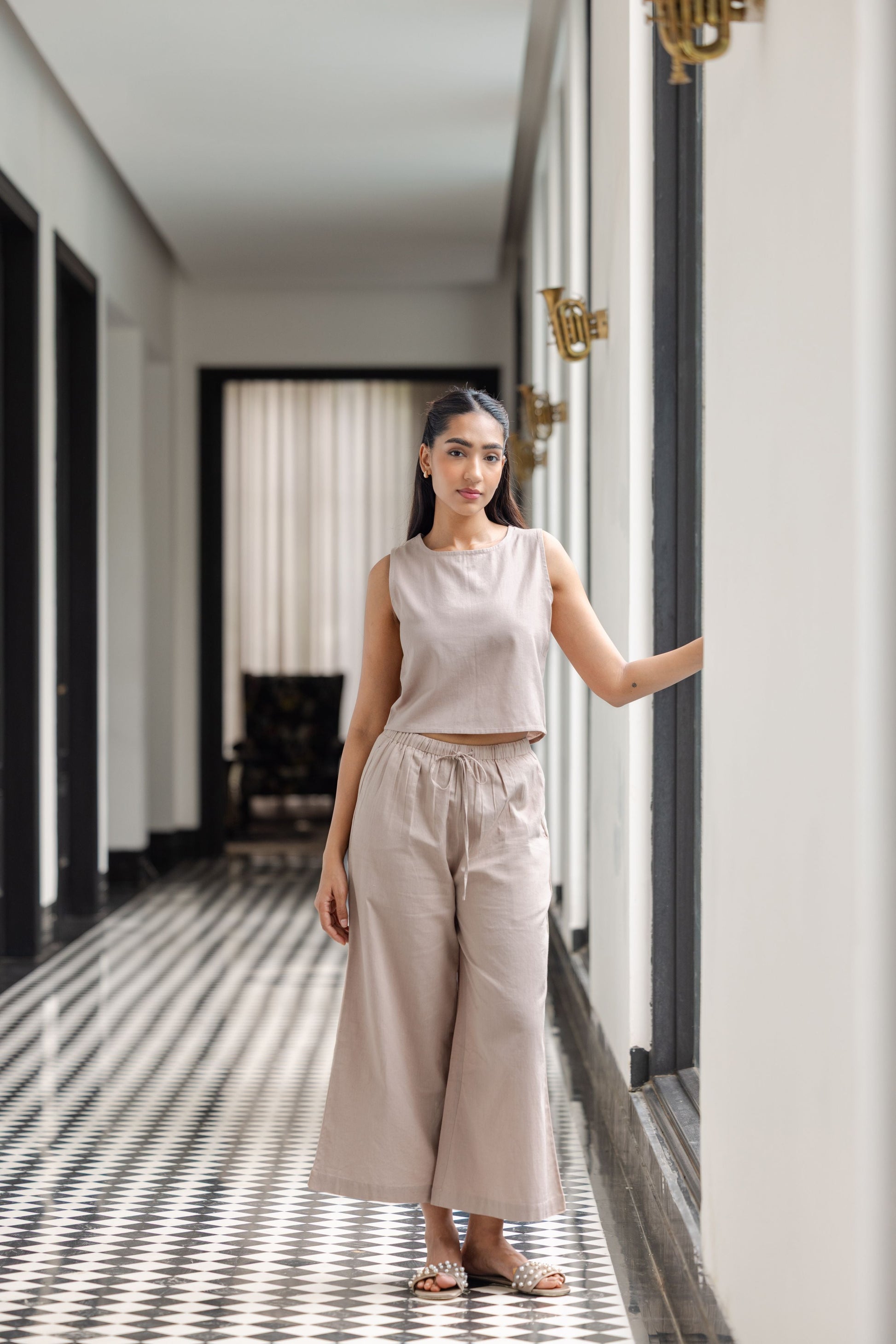 Sleeveless crop top paired with elastic-waist trousers