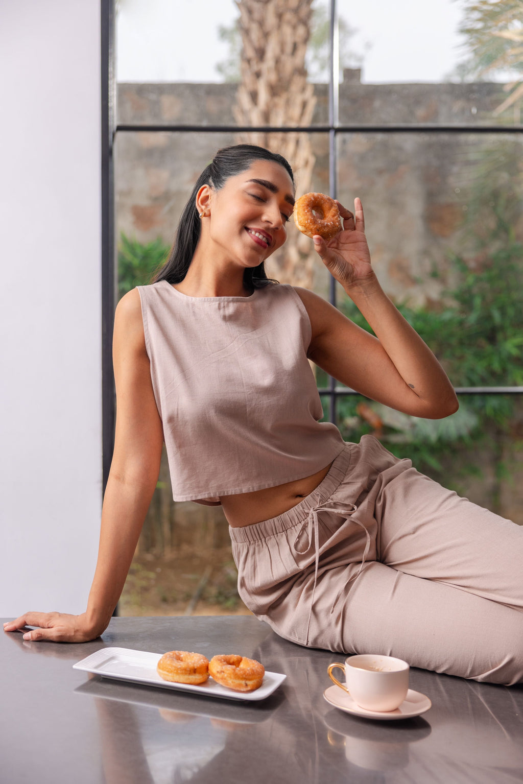 Woman wearing sleeveless crop top with elastic trousers co-ord set casual outfit